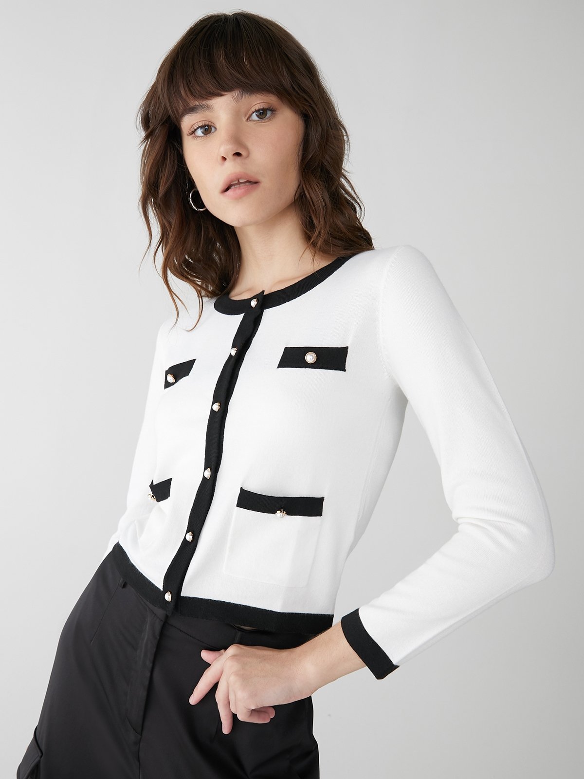 White cardigan deals with black trim